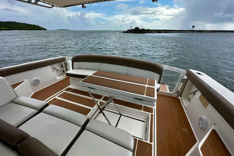  Yacht Photos Pics 2003 Tiara Yachts 4000 Express boat deck with seating and table, overlooking serene waters.