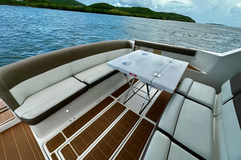  Yacht Photos Pics 2003 Tiara Yachts 4000 Express interior with seating and table, overlooking scenic water and greenery.