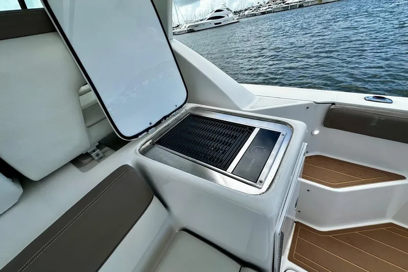  Yacht Photos Pics 2003 Tiara Yachts 4000 Express with built-in grill, docked by the water.