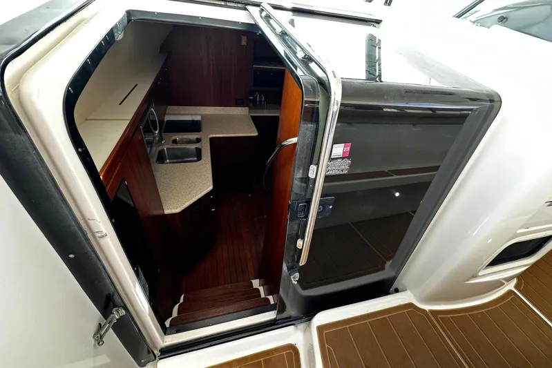  Yacht Photos Pics 2003 Tiara Yachts 4000 Express interior view with kitchenette and wooden flooring.