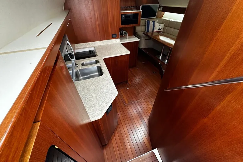  Yacht Photos Pics 2003 Tiara Yachts 4000 Express interior with wood finish and modern kitchen amenities.
