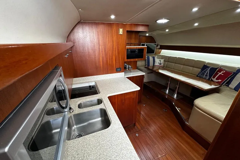  Yacht Photos Pics Luxurious interior of 2003 Tiara Yachts 4000 Express with modern kitchen and cozy seating area.