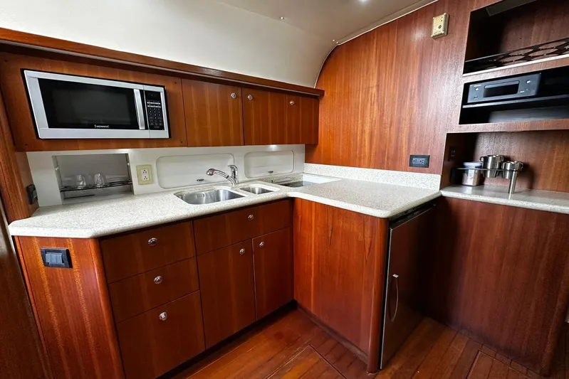  Yacht Photos Pics Luxurious 2003 Tiara Yachts 4000 Express kitchen with wood cabinetry and modern appliances.