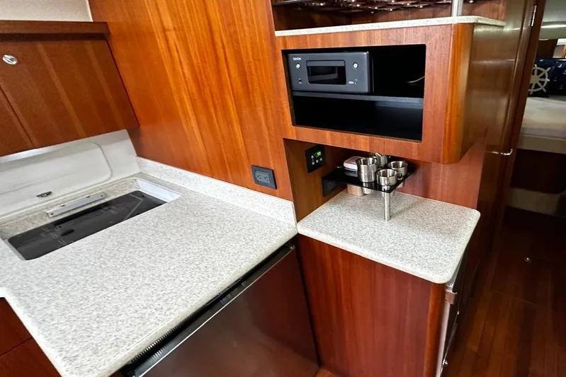  Yacht Photos Pics 2003 Tiara Yachts 4000 Express interior with wood cabinetry and modern kitchen amenities.