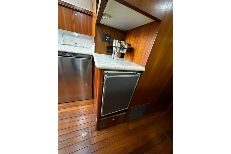  Yacht Photos Pics 2003 Tiara Yachts 4000 Express galley with wood cabinetry and stainless steel appliances.