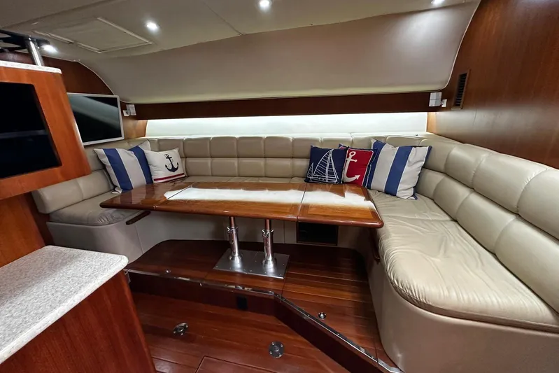  Yacht Photos Pics Luxurious 2003 Tiara Yachts 4000 Express interior with leather seating and nautical-themed pillows.