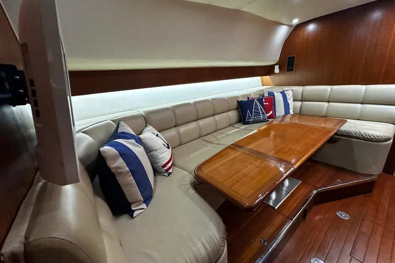  Yacht Photos Pics Luxurious interior of 2003 Tiara Yachts 4000 Express with plush seating and wooden table.