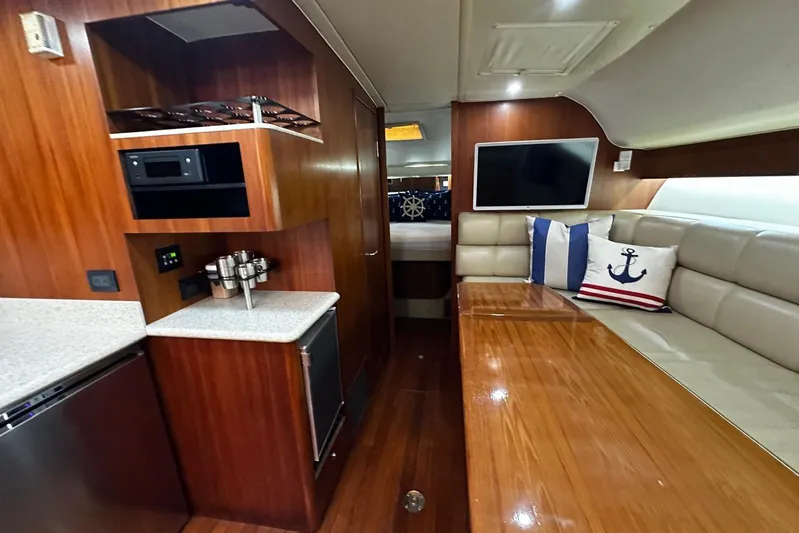  Yacht Photos Pics Luxurious interior of 2003 Tiara Yachts 4000 Express with wood finishes and nautical decor.