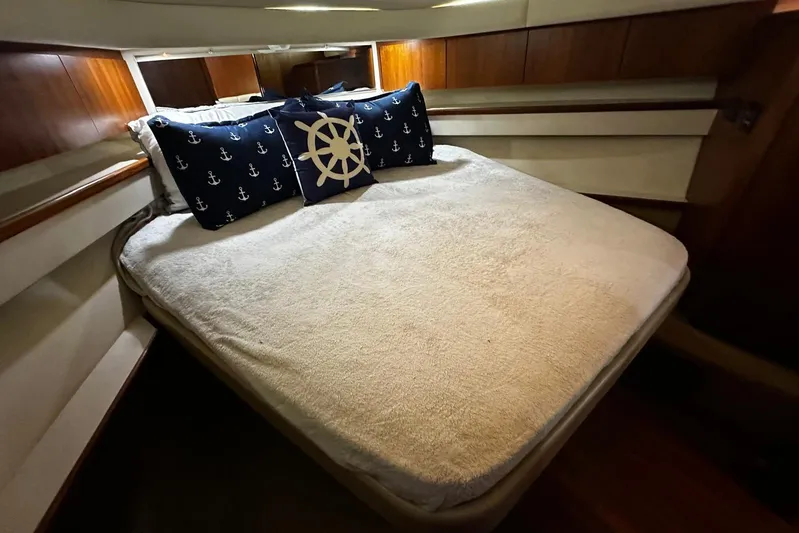  Yacht Photos Pics Cozy bedroom in 2003 Tiara Yachts 4000 Express with nautical-themed pillows.