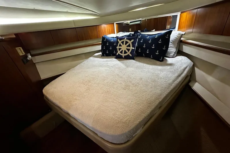  Yacht Photos Pics Cozy bedroom in 2003 Tiara Yachts 4000 Express with nautical-themed pillows.