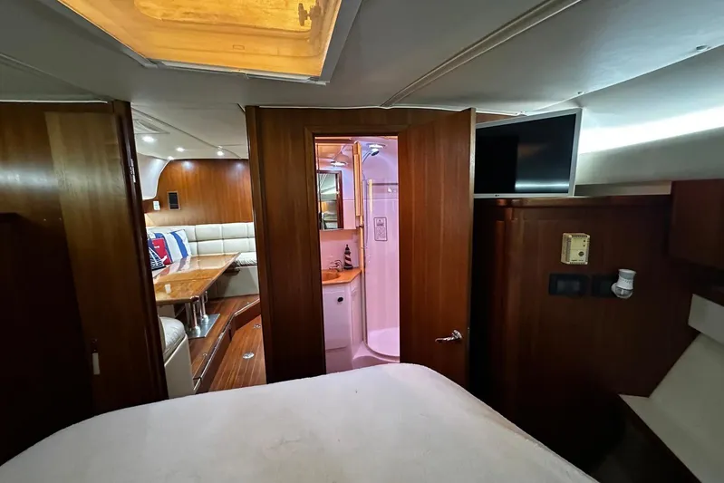 Yacht Photos Pics 2003 Tiara Yachts 4000 Express interior with wood finish, dining area, and bathroom.