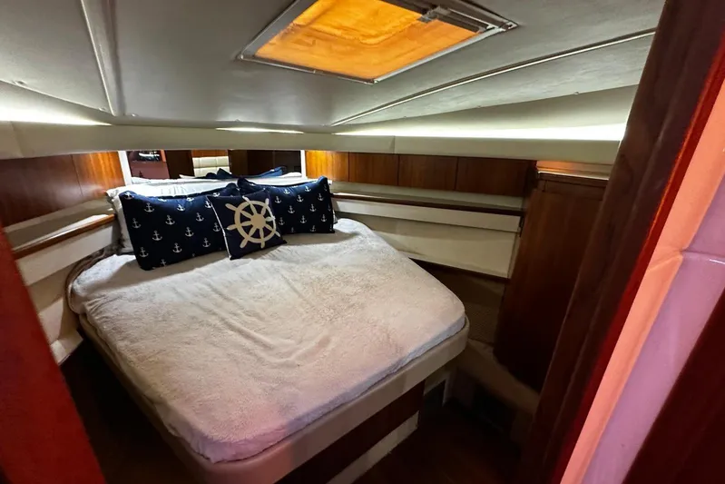  Yacht Photos Pics 2003 Tiara Yachts 4000 Express cabin with nautical-themed bedding and wood accents.