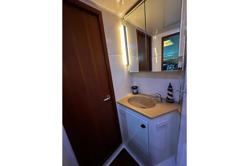  Yacht Photos Pics Bathroom interior of 2003 Tiara Yachts 4000 Express with sink and mirror.