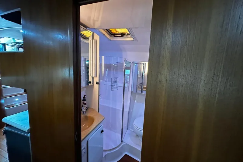  Yacht Photos Pics Bathroom interior of 2003 Tiara Yachts 4000 Express, featuring shower and sink.