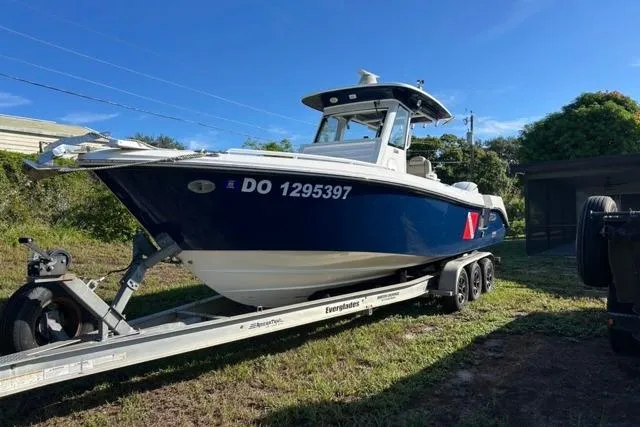  Yacht Photos Pics 2019 Everglades 290 Center Console boat on trailer, parked outdoors under clear blue sky.