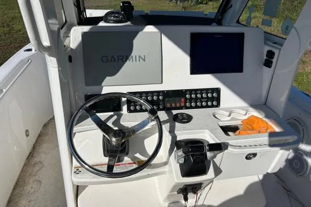  Yacht Photos Pics 2019 Everglades 290 Center Console boat dashboard with Garmin navigation system and steering wheel.