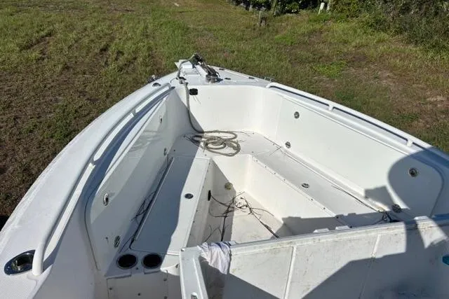  Yacht Photos Pics 2019 Everglades 290 Center Console boat on grassy terrain, showing spacious deck layout.