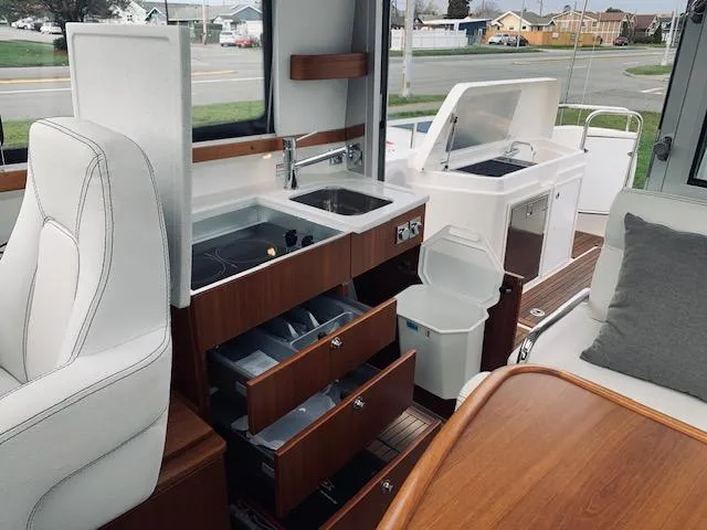 Ya Bawwt It Yacht Photos Pics Interior of 2017 Nimbus 34 Nova boat with kitchen and seating area.