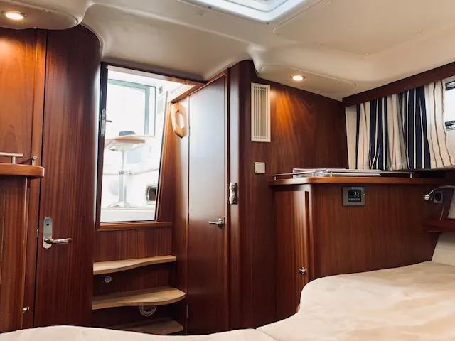 Ya Bawwt It Yacht Photos Pics Luxurious interior of 2017 Nimbus 34 Nova yacht with wooden finishes and cozy lighting.