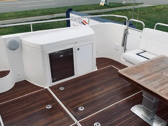 Ya Bawwt It Yacht Photos Pics Nimbus 34 Nova 2017 boat deck with wooden flooring and seating area.