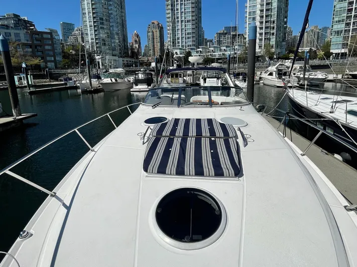 Samari Yacht Photos Pics 2007 Regal 3760 Sportyacht docked in a marina with city skyline background.