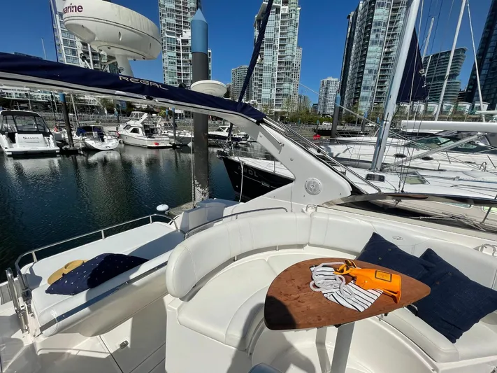 Samari Yacht Photos Pics 2007 Regal 3760 Sportyacht docked in marina with city skyline backdrop.