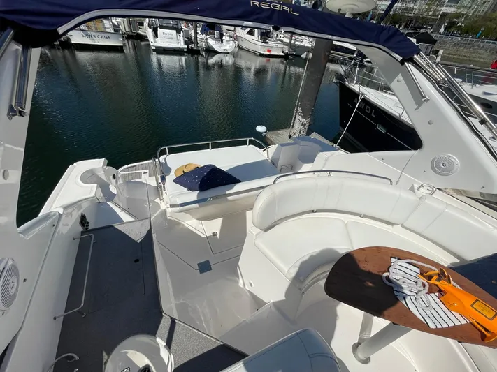 Samari Yacht Photos Pics 2007 Regal 3760 Sportyacht with white seating, docked at marina.