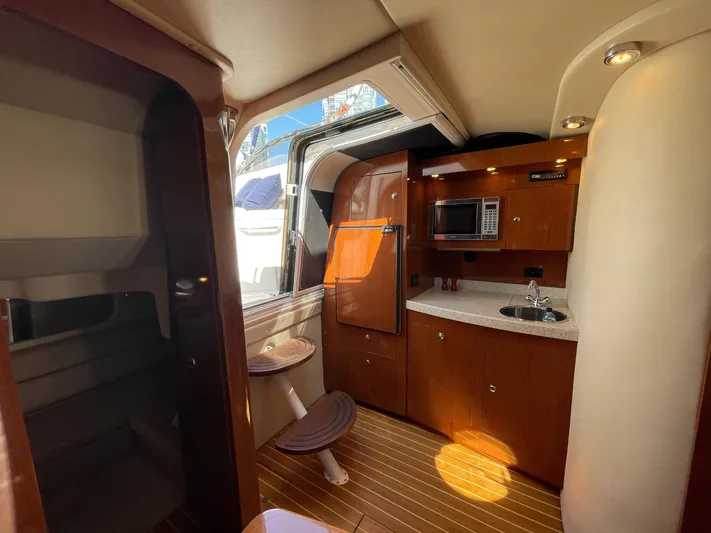 Samari Yacht Photos Pics Interior of 2007 Regal 3760 Sportyacht with kitchenette and wooden cabinetry.