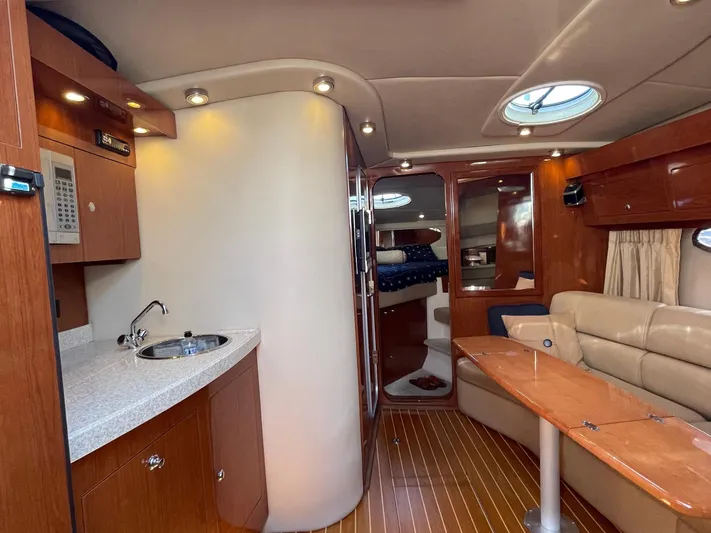 Samari Yacht Photos Pics Interior of 2007 Regal 3760 Sportyacht with kitchenette, seating, and wood finishes.