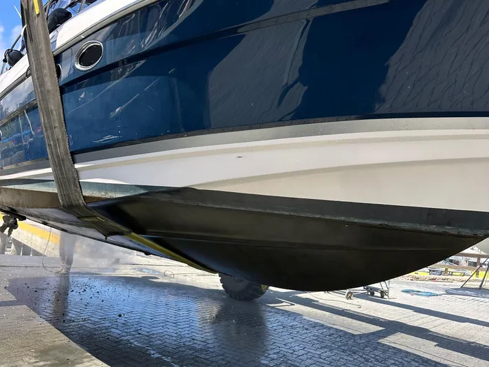 Samari Yacht Photos Pics 2007 Regal 3760 Sportyacht being lifted, showcasing sleek hull design.