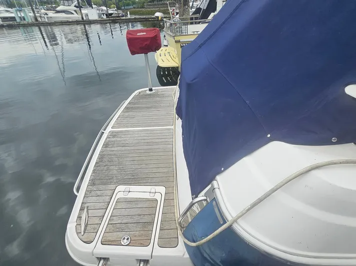 Samari Yacht Photos Pics 2007 Regal 3760 Sportyacht docked, featuring a wooden swim platform and blue cover.