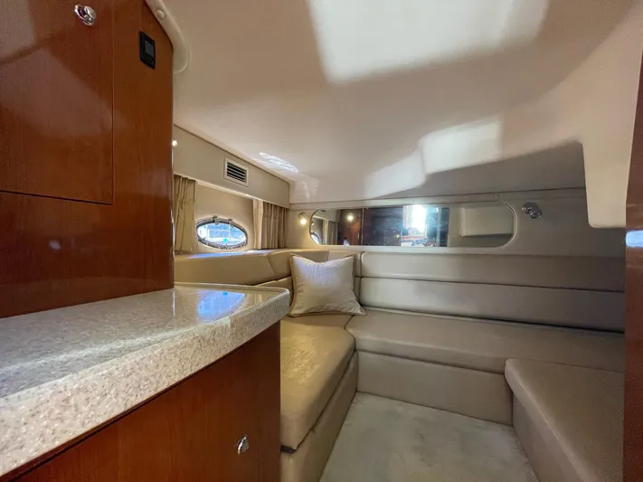 Samari Yacht Photos Pics 2007 Regal 3760 Sportyacht interior with beige seating and wooden cabinetry.