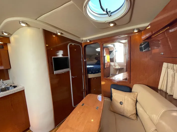 Samari Yacht Photos Pics 2007 Regal 3760 Sportyacht interior with wood finish, seating, and porthole.