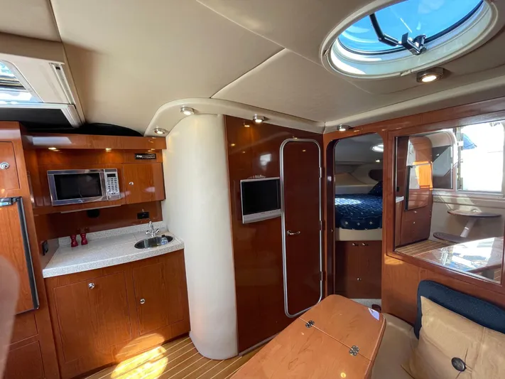 Samari Yacht Photos Pics 2007 Regal 3760 Sportyacht interior with kitchenette, seating, and sleeping area.