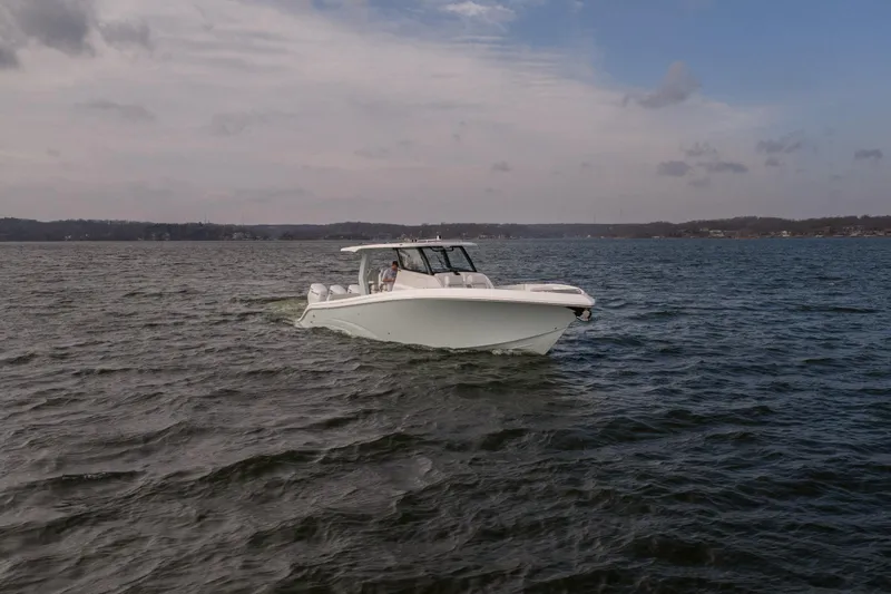  Yacht Photos Pics 2026 Fountain 43 SCX boat cruising on a calm lake under a cloudy sky.