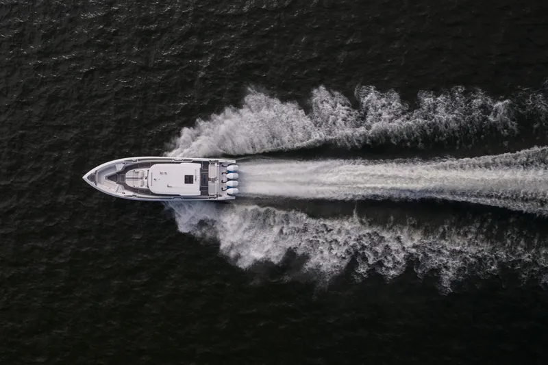  Yacht Photos Pics Aerial view of 2026 Fountain 43 SCX speedboat cutting through water.