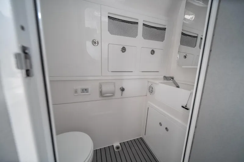  Yacht Photos Pics Modern bathroom interior in 2026 Fountain 43 SCX boat, featuring sleek design and compact amenities.