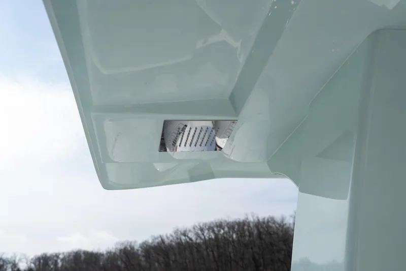  Yacht Photos Pics Close-up of 2026 Fountain 43 SCX boat's sleek hull design against a cloudy sky.