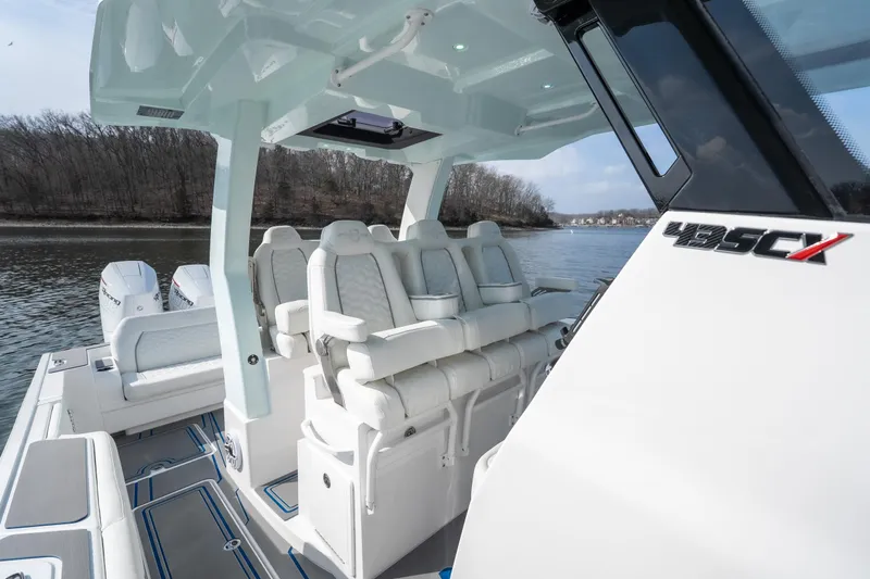  Yacht Photos Pics 2026 Fountain 43 SCX boat with luxurious seating on a calm river.