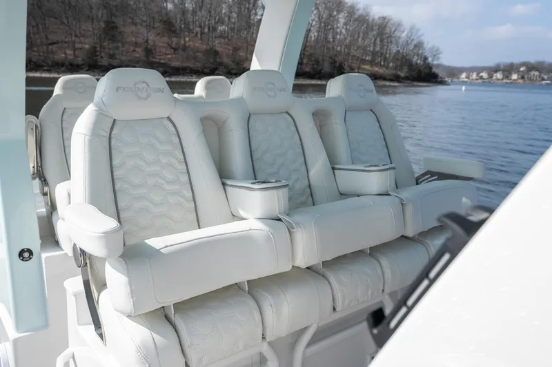  Yacht Photos Pics Luxury seating on 2026 Fountain 43 SCX boat, featuring plush white upholstery and armrests.
