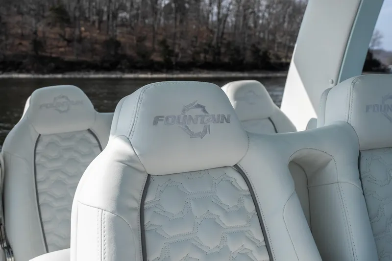  Yacht Photos Pics Luxurious white seats in 2026 Fountain 43 SCX boat, featuring embossed logo design.