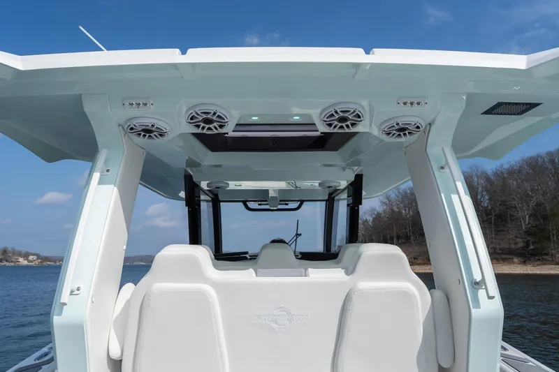  Yacht Photos Pics 2026 Fountain 43 SCX boat interior with speakers and seating, on a lake under blue sky.