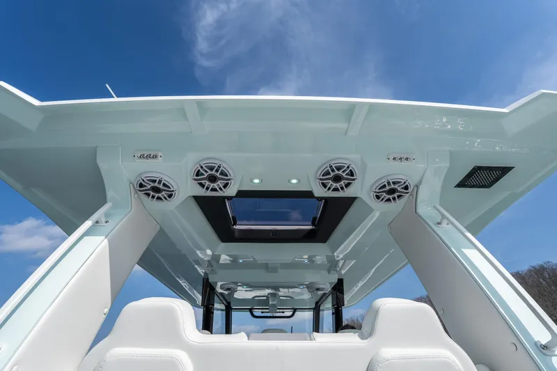  Yacht Photos Pics 2026 Fountain 43 SCX boat interior with speakers and skylight under a clear blue sky.