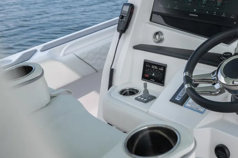  Yacht Photos Pics 2026 Fountain 43 SCX boat cockpit with steering wheel and navigation controls.