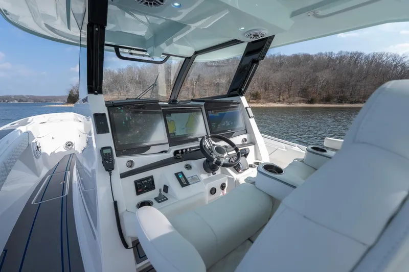  Yacht Photos Pics 2026 Fountain 43 SCX boat cockpit with advanced navigation systems on a serene lake.
