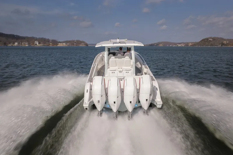  Yacht Photos Pics 2026 Fountain 43 SCX boat speeding on a lake with four powerful engines.