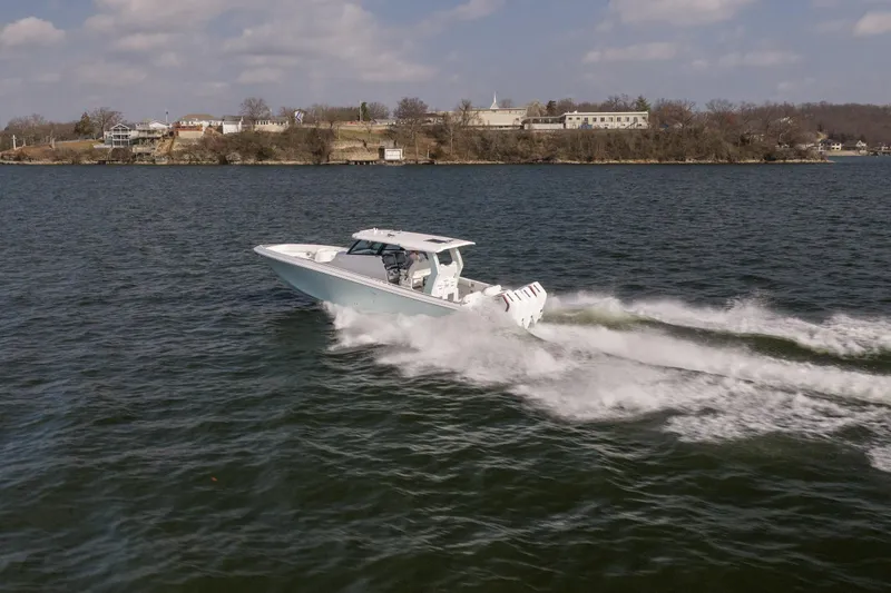  Yacht Photos Pics 2026 Fountain 43 SCX speedboat cruising on a lake under a partly cloudy sky.