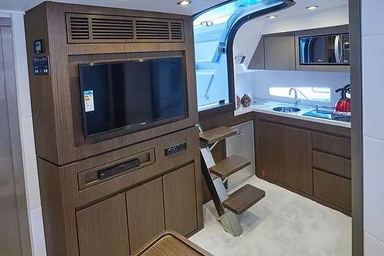  Yacht Photos Pics Luxurious interior of 2026 Schaefer 400 yacht with modern kitchen and entertainment area.