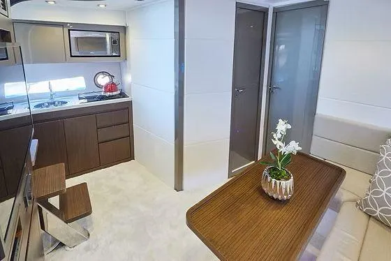 Yacht Photos Pics Modern yacht interior with kitchenette, dining area, and elegant decor in Schaefer 400, 2026 model.