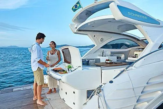  Yacht Photos Pics Couple enjoying leisure time on a 2026 Schaefer 400 yacht, ocean backdrop.